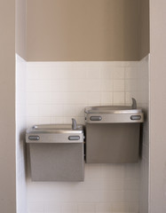 Two indoor silver water fountains