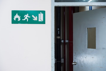 Fire exit sign in the airport terminal emergency exit way.Thailand.