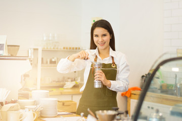 Asian woman make coffee latte in coffee shop cafe barista concept