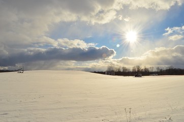 Snow covered rolling hills in the country on a sunny winter day