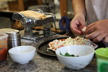 hand of chef making pizza at homemade kitchen