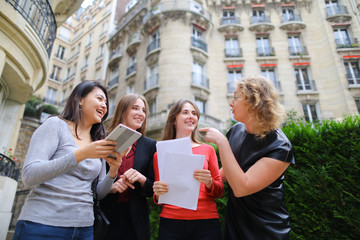 International students paying with card with tablet in   near un