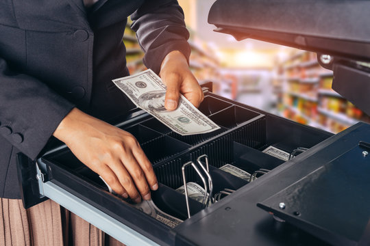 Female Hand With Money In Supermarket Shop. American Dollar. Us Dollar. Cash On Cashier's Desk. Hand Giving Cash. Payday Paying Cashier Access.