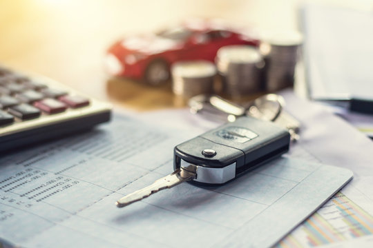 Car Key With Money And Calculator On Table. Concept Finance And Insurance