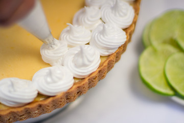 Fototapeta na wymiar Lemon pie with meringue in decoration process
