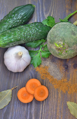 2692957 Vegetables on wooden background scattering of spices and a Bay leaf parsley sprig