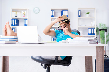 Businessman preparing for vacation in the office