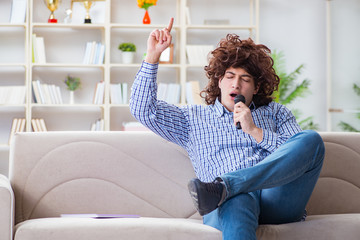 Funny man singing songs in karaoke at home