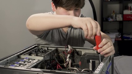 A Computer Genius Boy Fixing the problem in Computer. .Child repair the PC and remove the hardware..Released