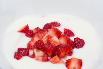 Cut strawberry with natural yogurt close up. macro