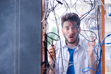 Computer repairman working on repairing network in IT workshop