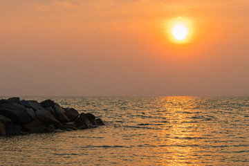 Fototapeta na wymiar Sunrise in the sea with soft wave and cloudy.