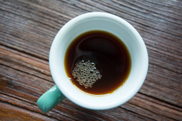 Close-up a cup of coffee drip on wooden board 