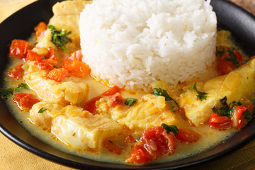 Pescado encocado or fish with coconut sauce is an Ecuadorian coastal dish close-up on a plate. Horizontal © FomaA