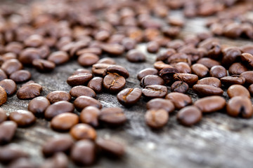 a lot of coffee beans on wooden ground
