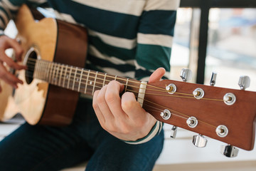 Learning to play the guitar. Music education and extracurricular lessons. Hobbies and enthusiasm...