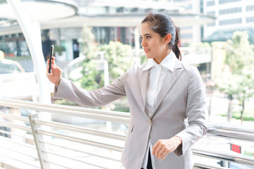 Portrait beautiful business woman take selfie with smartphone at outdoors. concept of communication and video call.