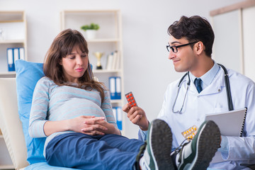 Fototapeta premium Pregnant woman visiting doctor for consultation