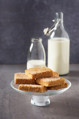 Slices of homemade sugar crumble cake on a glass plate. Sweet dessert. Selective focus. 
