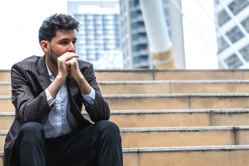 Unemployed businessman stress sitting on stair, concept of business failure and unemployment problem, work life balance.