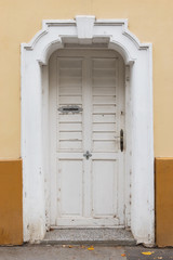 Fototapeta premium Front view of old rustic white front door
