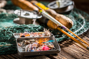 Handmade angler equipment with fishing flies and rods