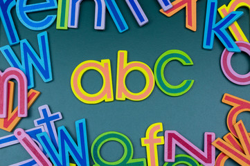 Close up arrangement of alphabet on green board. Preschool, education concept or other your content.