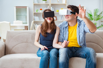 Young family playing games with virtual reality glasses
