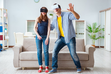 Young family playing games with virtual reality glasses