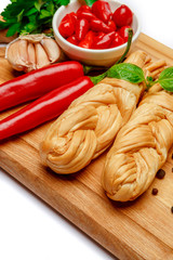 Smoked braided cheese and red pepper on white background