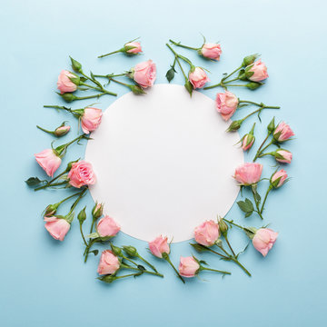 Flowers Composition. Wreath Made Of Pink Rose Flowers On Blue Background. Flat Lay, Top View, Copy Space.