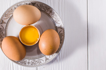 plate with chicken eggs on white boards