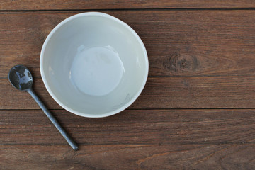 Bowls and Ceramic Spoons on Wooden background