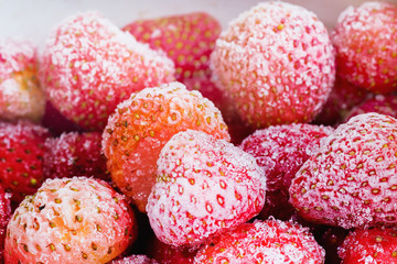 Frozen strawberries in a white plate