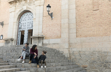 Mother and daughters sitting on the stairs