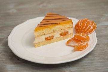 Slice of mandarine cake on a white plate