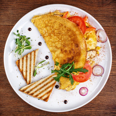 Pancakes with vegetables, crackers and microgreen.