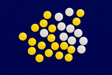 Pills on blue background.
