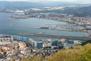 Aerial view on city and airport runway of Gibraltar and Spanish La Linea town on a background.