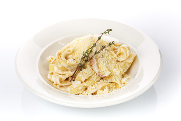 Homemade noodles in a plate with sauce.