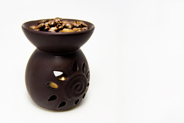 tea light candle heat oil perfume diffuser with coffee beans on the top. for aroma therapy concept