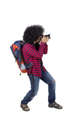 Young photographer using a camera on studio