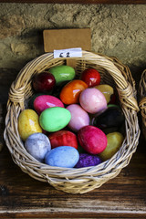 Fototapeta na wymiar Wicker basket with Easter eggs of different colors