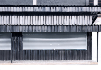 Shutter roller door aluminium and sheet metal zinc  texture corrugated gray and black with copy space for text. Design for a restaurant.