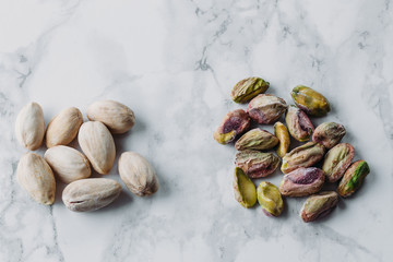 Roasted and salted pistachios nuts on marble background