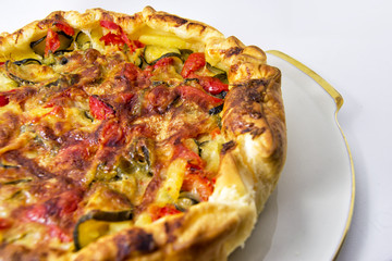 vegetables salad pie. quiche with zucchini, peppers, potatoes and puff pastry. for vegerarian cousine concept