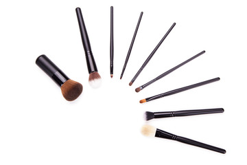 Various makeup brushes isolated over white background,Flat top view set of essential professional make-up brushes on white background. Copy space for your text