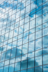 Fototapeta na wymiar Glass facade of modern city high buildings, cloud reflection