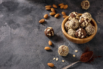 Vegan sweet bites, raw eating dessert with nuts and cacao, sesam and oats, copy space