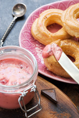 Delicate berry souffle was smeared on the eclair.